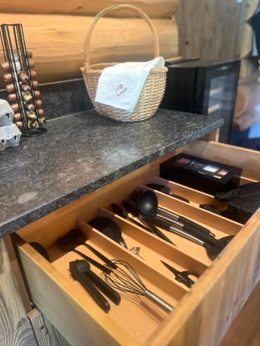 a drawer in a cabinet filled with utensils at RaxChalet in Prein