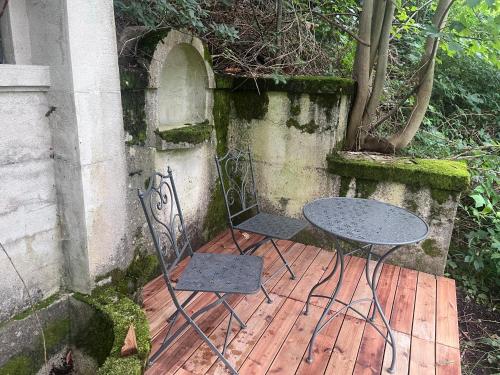 two chairs and a table on a wooden deck at RaxChalet in Prein