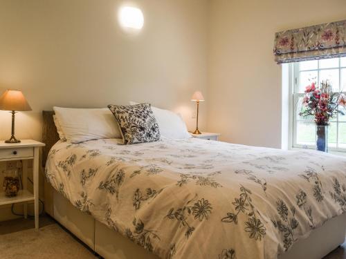 a bedroom with a bed and a window at The Mount View in Towcester
