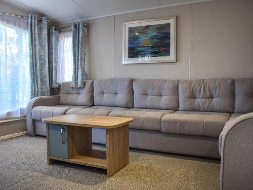 a living room with a couch and a coffee table at Unit 44 in Weybourne