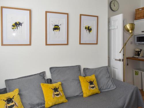 a living room with a couch with yellow pillows at Trinity Bee in Ventnor