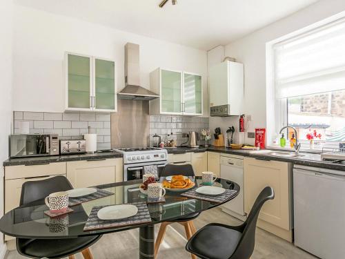 a kitchen with a table and chairs in it at Castle Retreat in Skipton