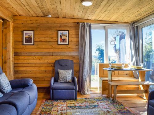 a living room with a couch and a chair and a table at Alpaca Lodge in Acton
