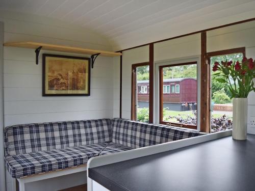 sala de estar con sofá y ventanas en Italian Carriage-Ukc3492, en Wetheringsett