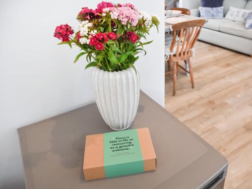 a vase with flowers sitting on top of a table at Beach Escape in Bacton