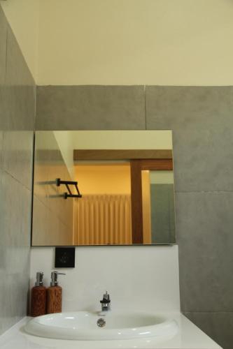 a bathroom sink with a mirror and a sink at Permata Villas Lombok in Kuta Lombok