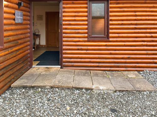 an open door of a house with a wooden wall at Fois Bhrus in White Bridge