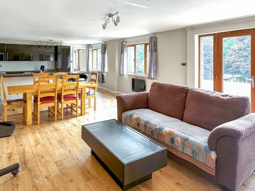 a living room with a couch and a table at Spring Vale Bungalow in Colchester