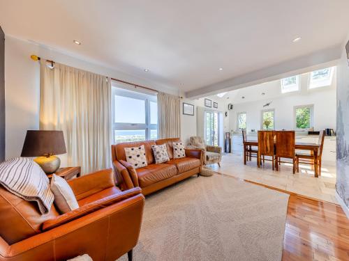 a living room with a couch and a dining room at Baobab Lodge in Prestatyn