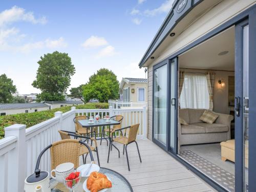 a balcony with a table and chairs and a couch at Bay View 34 in Weymouth