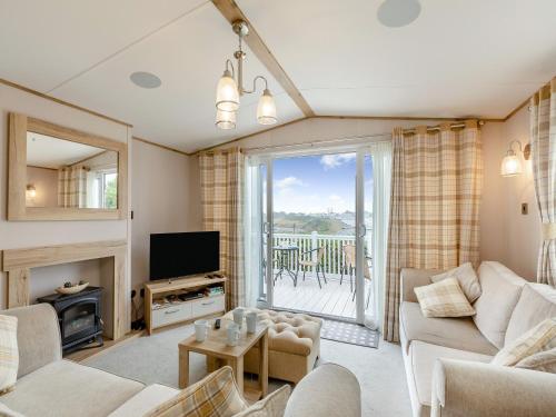 a living room with a couch and a television at Bay View 34 in Weymouth