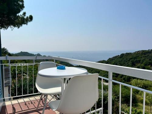 a white table and two chairs on a balcony at Hotel Sant'Andrea in Marciana