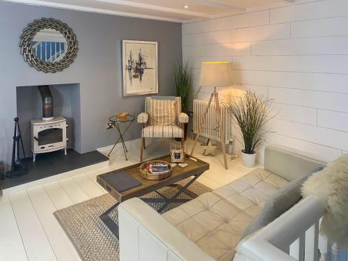 a living room with a couch and a table at Gylly Cottage in Mousehole