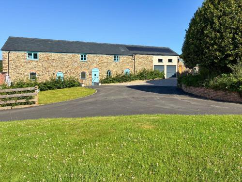 a brick house with a driveway in front of it at Lavender Cottage -Uk49209 in Jacobstowe