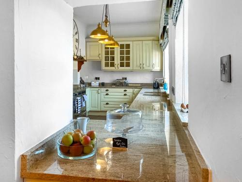a kitchen with a bowl of fruit on a counter at The Farmhouse in Purston Jaglin