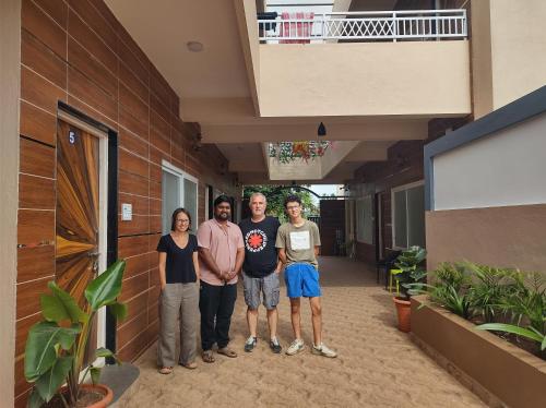 a group of people standing outside of a building at Shanthi Guest House in Hampi
