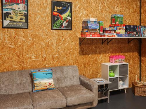 a living room with a couch and shelves with toys at Awel Deg - Uk49672 in Brynsiencyn