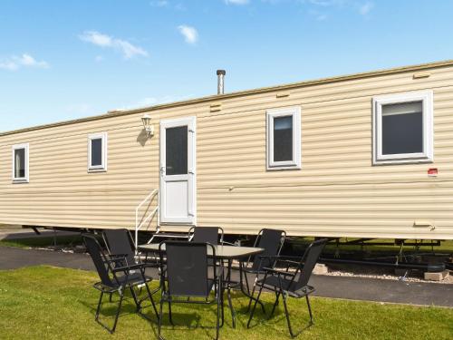 a table and chairs in front of a trailer at The Getaway - Uk49617 in Lancaster