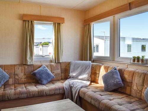 a living room with a couch and two windows at The Getaway - Uk49617 in Lancaster