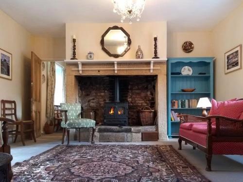 a living room with a fireplace and a mirror at Tower Cottage - Uk49339 in Whittingham