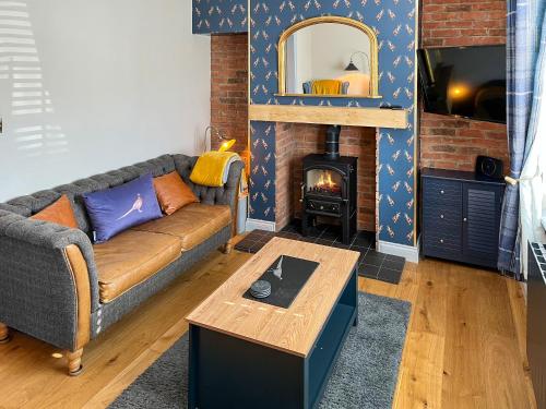 a living room with a couch and a fireplace at Lily Pad - Uk49104 in Helmsley