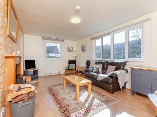 a living room with a couch and a table at Walled Cottage - Uk49097 in Inchnadamph
