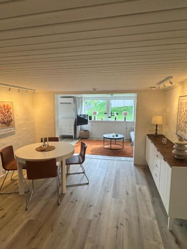 a room with a table and chairs and a living room at Nyrenoverad 2-rummare med gratis laddning för elbil in Bankeryd