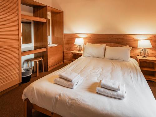 a bedroom with a bed with two towels on it at Macallan Lodge - Uk49119 in Feshiebridge