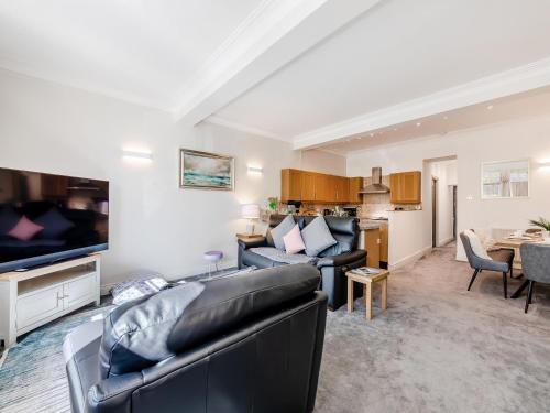 a living room with a couch and a tv at Riverview Retreat in Ebchester