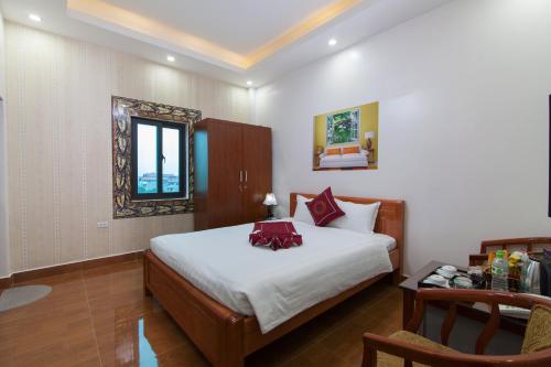 a bedroom with a bed and a table and a window at Luxury Airport Hotel & Travel in Noi Bai