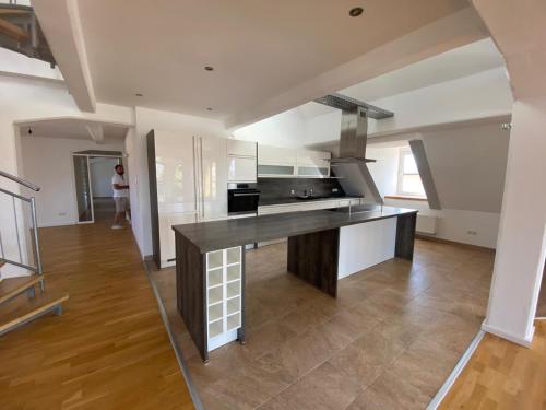 a kitchen with a black counter top in a room at Vorverkauf Penthouse Loft Bamberg in Bamberg