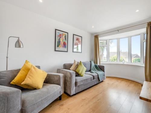 a living room with two couches and a window at Beach House in Seaford