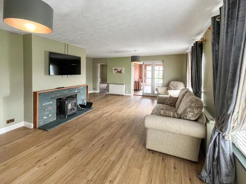 a living room with a couch and a fireplace at Violet Bank in Cockermouth