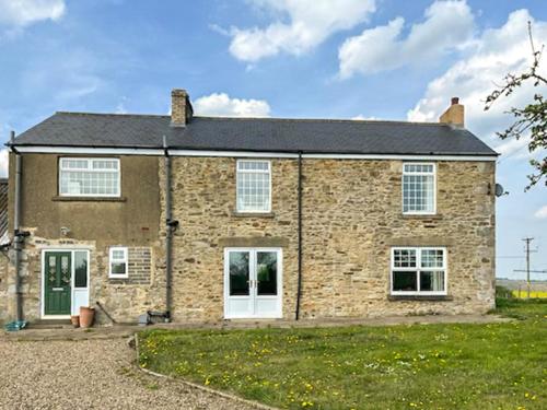 a brick house with white doors and windows at Middle Farm in Durham