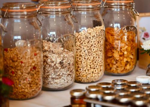 a bunch of glass jars filled with different types of food at The Bakery B&B in Westerham