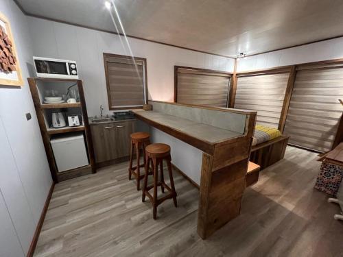 a kitchen with a large wooden bar in a room at Aremko SPA in Puerto Varas