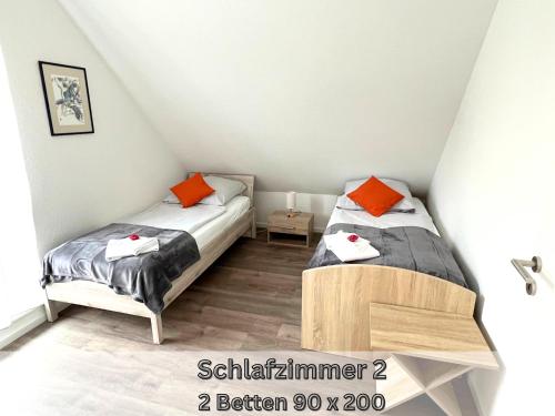Serviced Apartment " Nautilus " Papenburg Großer Balkon Einbauküche Neubau 74 qm Free Wifi 2 Schlafzimmerにあるベッド
