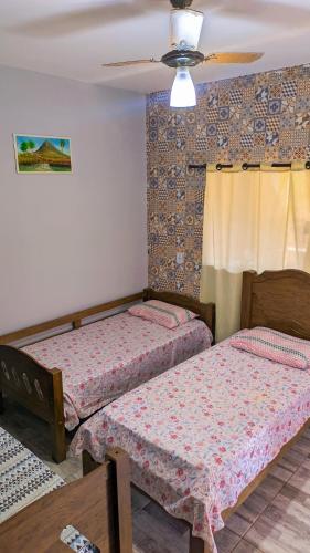 a bedroom with two beds and a ceiling at Pousada Rancho Dona Lú Comfort in Pereira Barreto