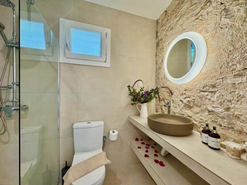 a bathroom with a toilet and a sink and a shower at Villa Eva Agni with private pool by DadoVillas in Agní