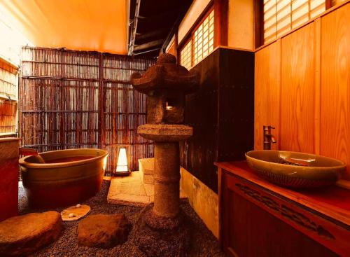 a bathroom with a tub and a sink at Basara Kinmokusei 金木犀Kyoto Machiya in Kyoto