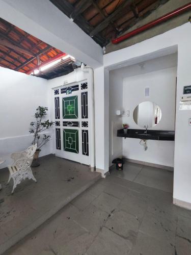 a room with a door with a mirror on the wall at Hotel Estação in Diamantina