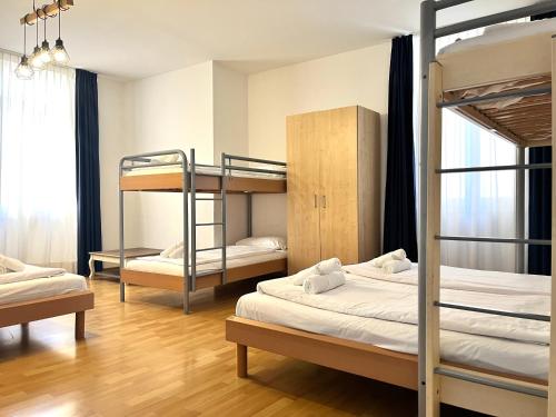 a room with two bunk beds and a window at GuestHouse Lugano Center by LR in Lugano