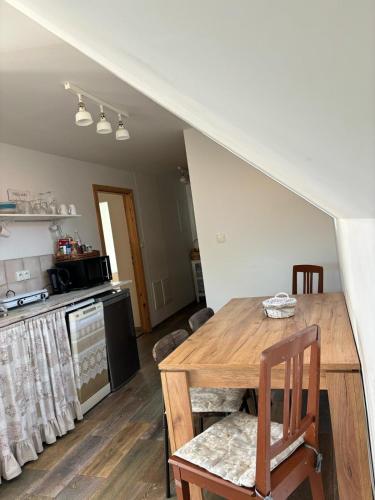 a kitchen and dining room with a wooden table at Ubytování Otín in Jindrichuv Hradec