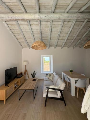 a living room with a couch and a table at Casa da Moura in Santiago do Cacém