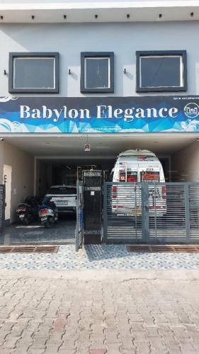 a building with a car garage with aption elegance at Hotel Babylon Elegance near krishna janam bhoomi in Mathura