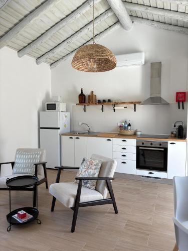 a kitchen with a table and chairs in a room at Casa da Moura in Santiago do Cacém