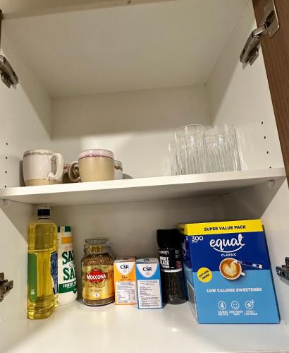 a shelf with some food items in a refrigerator at Stylish four bedroom family retreat in Saltwater Coast in Point Cook