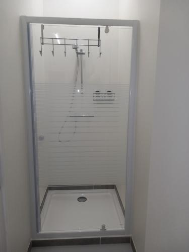 a shower in a bathroom with a glass door at Chez Jean-Claude Chambre 4 personnes in Wavre