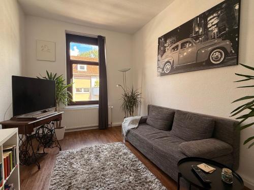 a living room with a couch and a car on the wall at Entspannt Mittendrin in Hannover
