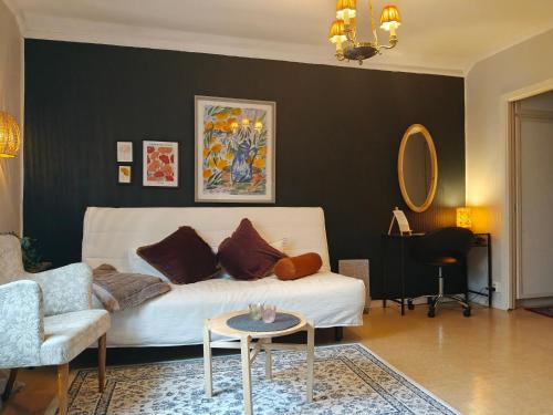a living room with a couch and a table at Central hel lägenhet. Nära till allt. in Umeå